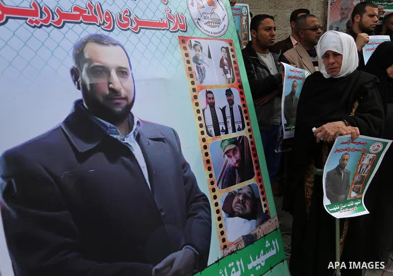 Palestinians take part during a protest denouncing an assassination of Hamas official, Mazen Faqha who was freed by Israel in a 2011 prisoner swap after he was shot dead by unknown gunmen, in front of Red cross office in...