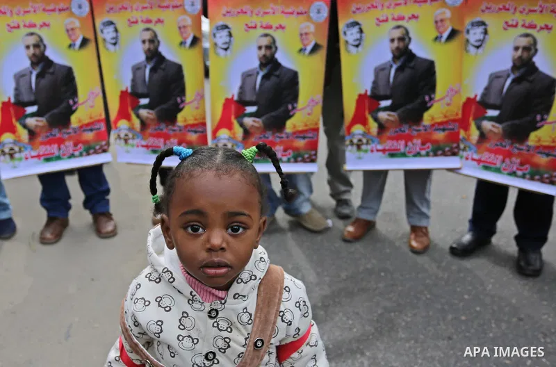 Palestinians take part during a protest denouncing an assassination of Hamas official, Mazen Faqha who was freed by Israel in a 2011 prisoner swap after he was shot dead by unknown gunmen, in front of Red cross office in...