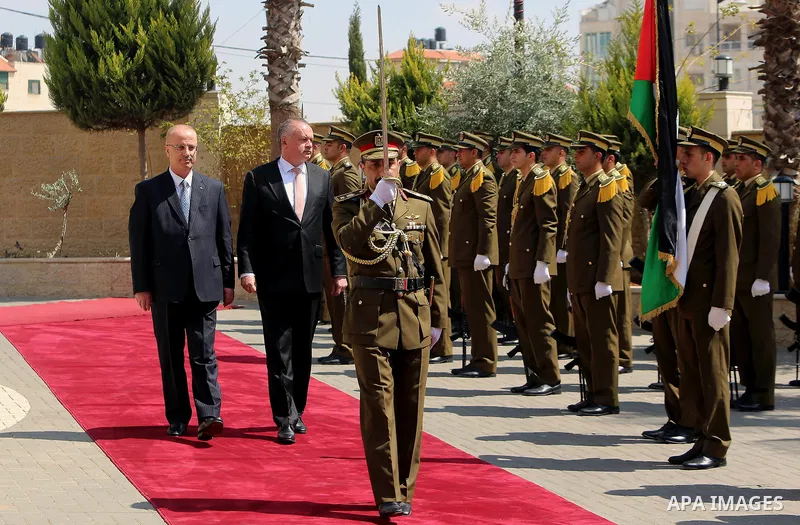 Palestinian Prime Minister Rami Hamdallah and Andrej Kiska, President of the Slovak Republic, inspect the honor guard in the West Bank city of Ramallah, on March 28, 2017. Photo by Prime Minister Office
