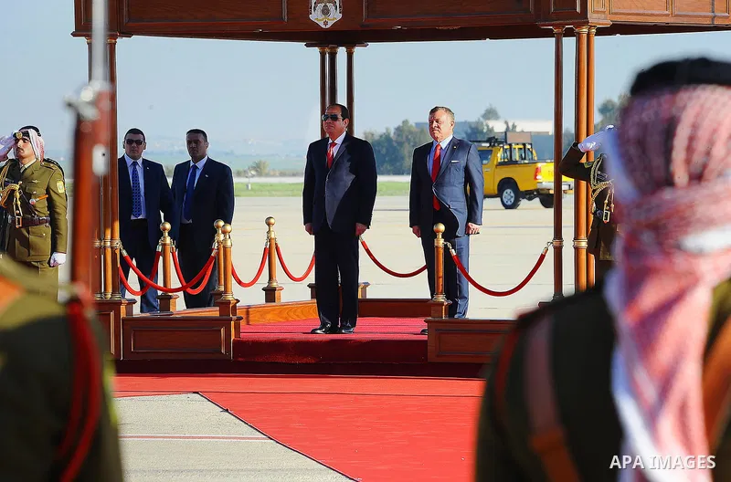 Jordan's King Abdullah II and Egyptian President Abdel Fattah al-Sisi listen to their national anthems during a welcome ceremony for the latter at the Queen Alia International Airport in Amman on March 28, 2017 ahead of...