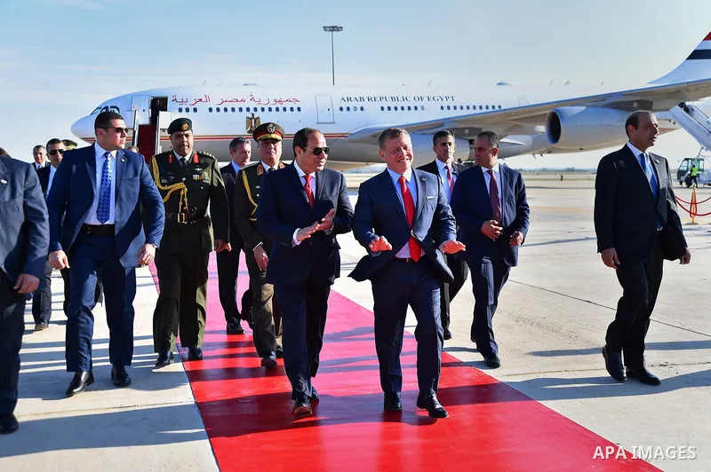 Jordan's King Abdullah II and Egyptian President Abdel Fattah al-Sisi listen to their national anthems during a welcome ceremony for the latter at the Queen Alia International Airport in Amman on March 28, 2017 ahead of...