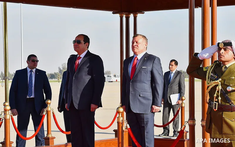 Jordan's King Abdullah II and Egyptian President Abdel Fattah al-Sisi listen to their national anthems during a welcome ceremony for the latter at the Queen Alia International Airport in Amman on March 28, 2017 ahead of...