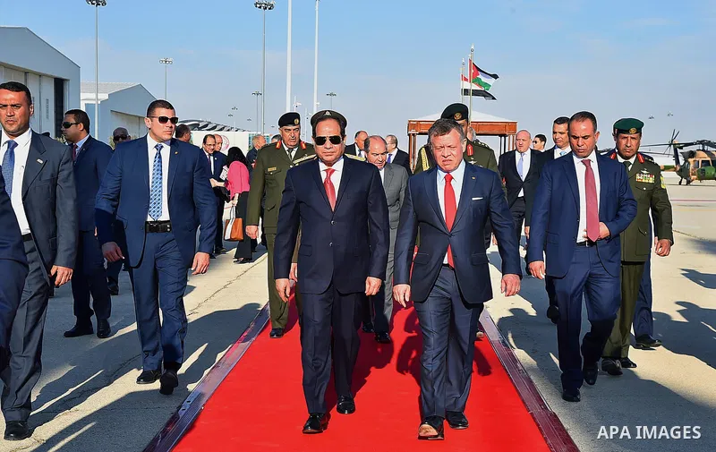 Jordan's King Abdullah II and Egyptian President Abdel Fattah al-Sisi listen to their national anthems during a welcome ceremony for the latter at the Queen Alia International Airport in Amman on March 28, 2017 ahead of...