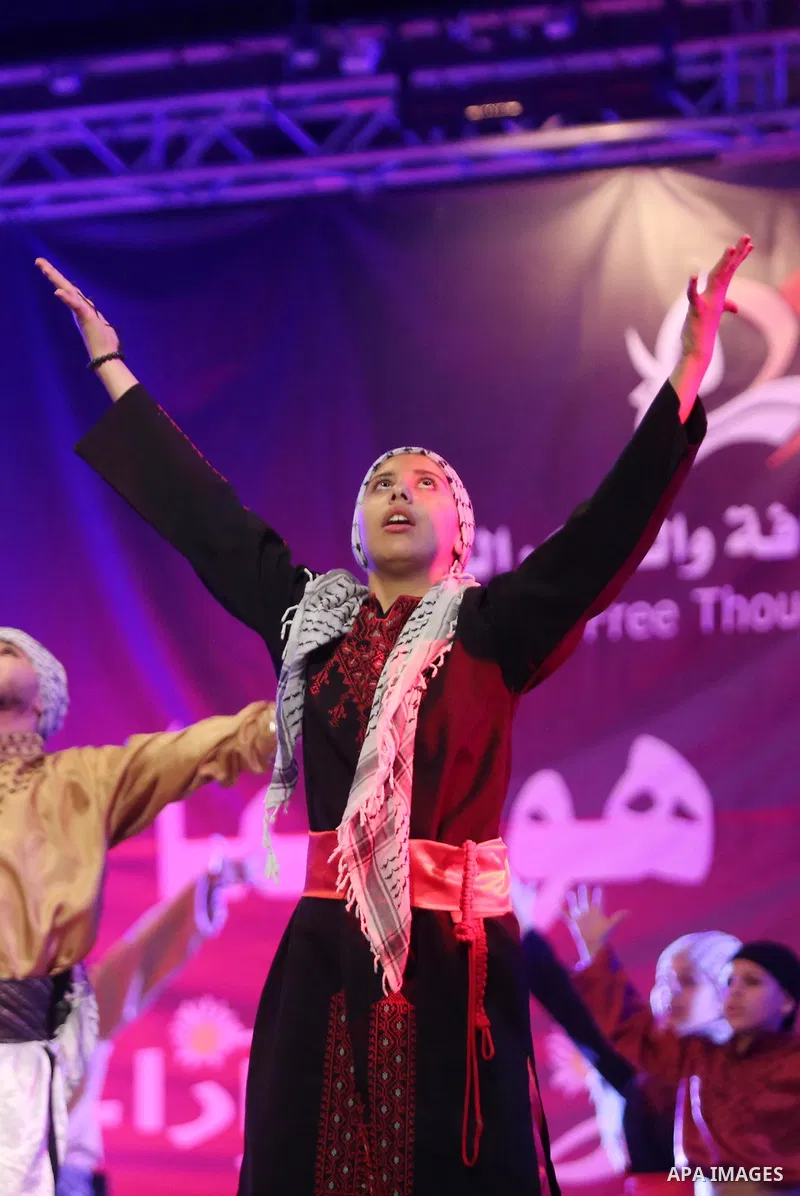 Palestinian youths perform a traditional dance during a festival titled "our land..our identity" marking the Land day in Gaza city on March 29, 2017. Photo by Ashraf Amra