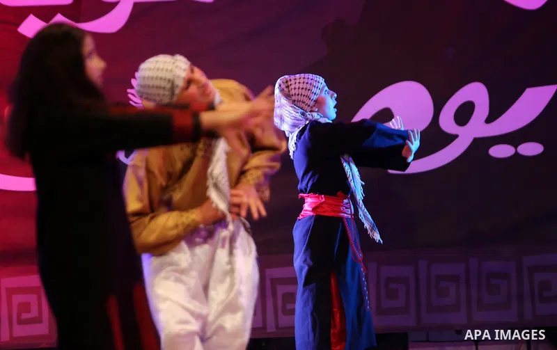 Palestinian youths perform a traditional dance during a festival titled "our land..our identity" marking the Land day in Gaza city on March 29, 2017. Photo by Ashraf Amra