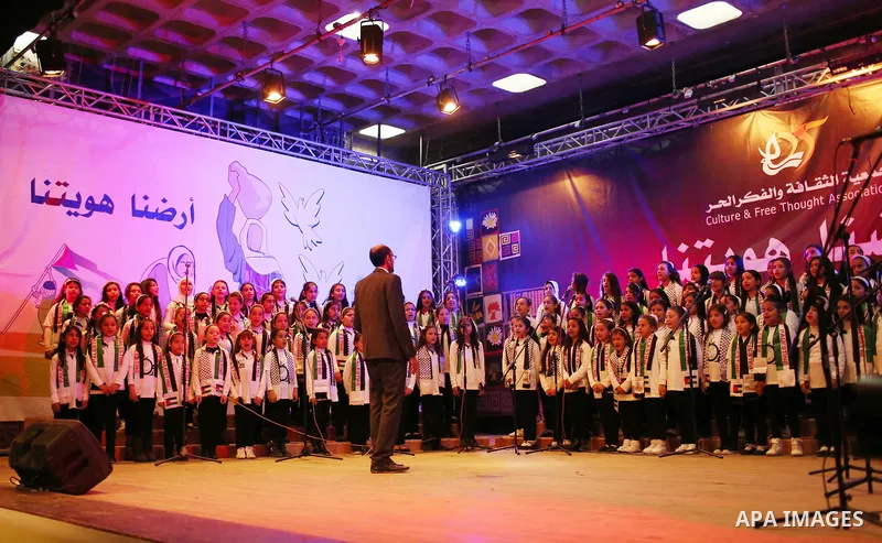 Palestinian children perform during a festival titled "our land..our identity" marking the Land day in Gaza city on March 29, 2017. Photo by Ashraf Amra