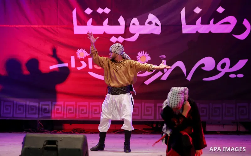 Palestinian youths perform a traditional dance during a festival titled "our land..our identity" marking the Land day in Gaza city on March 29, 2017. Photo by Ashraf Amra