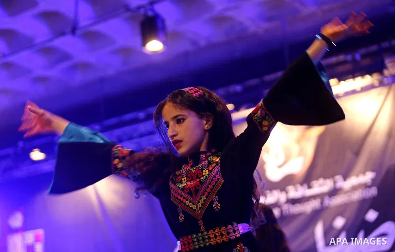 Palestinian children perform a traditional dance during a festival titled "our land..our identity" marking the Land day in Gaza city on March 29, 2017. Photo by Ashraf Amra