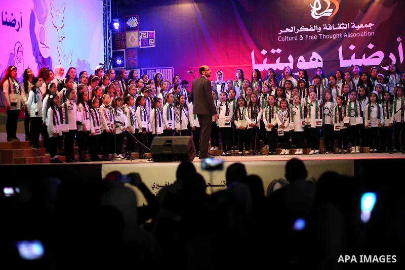 Palestinian children perform during a festival titled "our land..our identity" marking the Land day in Gaza city on March 29, 2017. Photo by Ashraf Amra