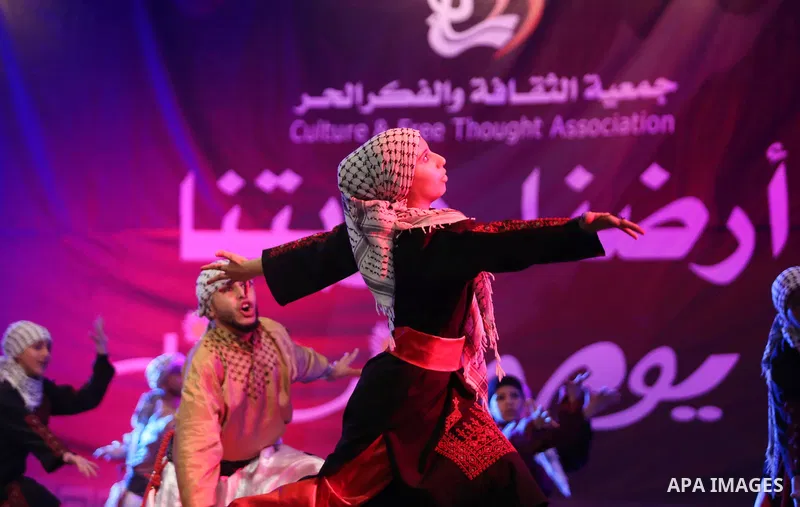 Palestinian youths perform a traditional dance during a festival titled "our land..our identity" marking the Land day in Gaza city on March 29, 2017. Photo by Ashraf Amra