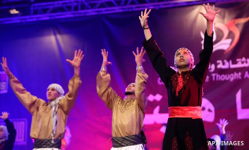 Palestinian youths perform a traditional dance during a festival titled "our land..our identity" marking the Land day in Gaza city on March 29, 2017. Photo by Ashraf Amra