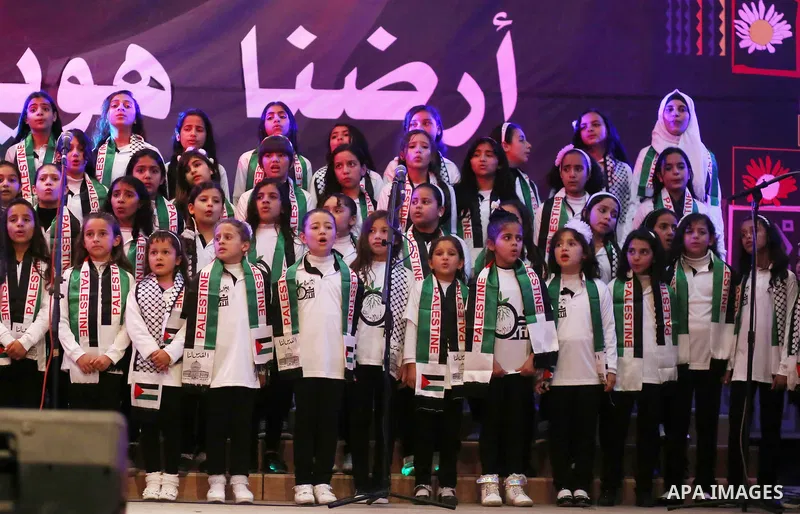Palestinian children perform during a festival titled "our land..our identity" marking the Land day in Gaza city on March 29, 2017. Photo by Ashraf Amra