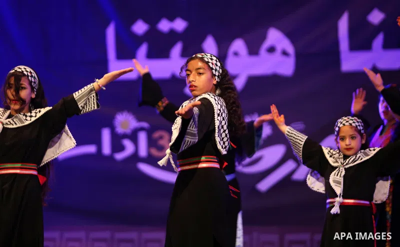 Palestinian children perform a traditional dance during a festival titled "our land..our identity" marking the Land day in Gaza city on March 29, 2017. Photo by Ashraf Amra