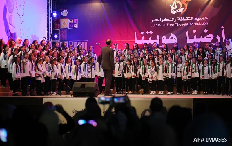 Palestinian children perform during a festival titled "our land..our identity" marking the Land day in Gaza city on March 29, 2017. Photo by Ashraf Amra