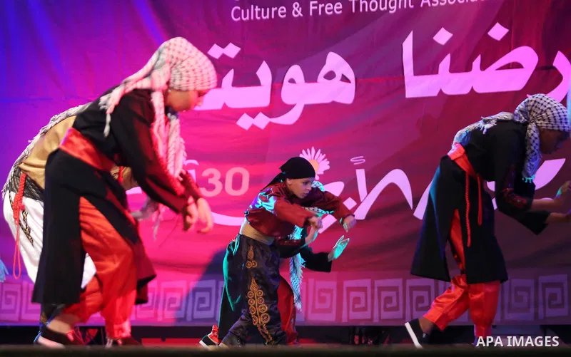 Palestinian youths perform a traditional dance during a festival titled "our land..our identity" marking the Land day in Gaza city on March 29, 2017. Photo by Ashraf Amra