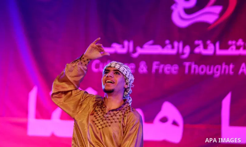 Palestinian youths perform a traditional dance during a festival titled "our land..our identity" marking the Land day in Gaza city on March 29, 2017. Photo by Ashraf Amra