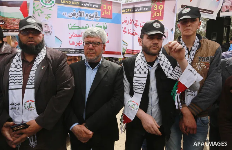 Palestinians hold banners and Palestine flags during a rally marking Land Day, near the Israeli border with northern Gaza Strip March 30, 2017. March 30 marks Land Day, the annual commemorations of the killing by police...