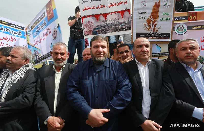 Palestinians hold banners and Palestine flags during a rally marking Land Day, near the Israeli border with northern Gaza Strip March 30, 2017. March 30 marks Land Day, the annual commemorations of the killing by police...