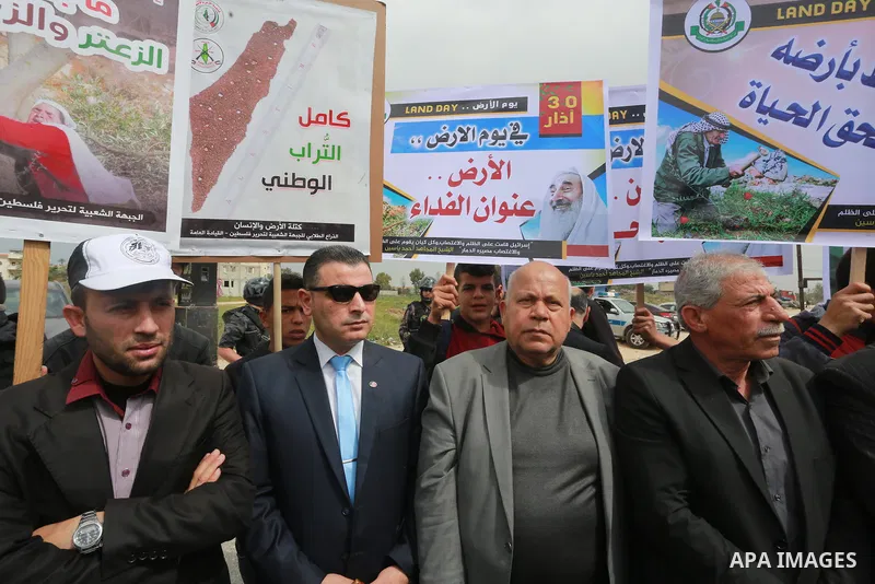 Palestinians hold banners and Palestine flags during a rally marking Land Day, near the Israeli border with northern Gaza Strip March 30, 2017. March 30 marks Land Day, the annual commemorations of the killing by police...