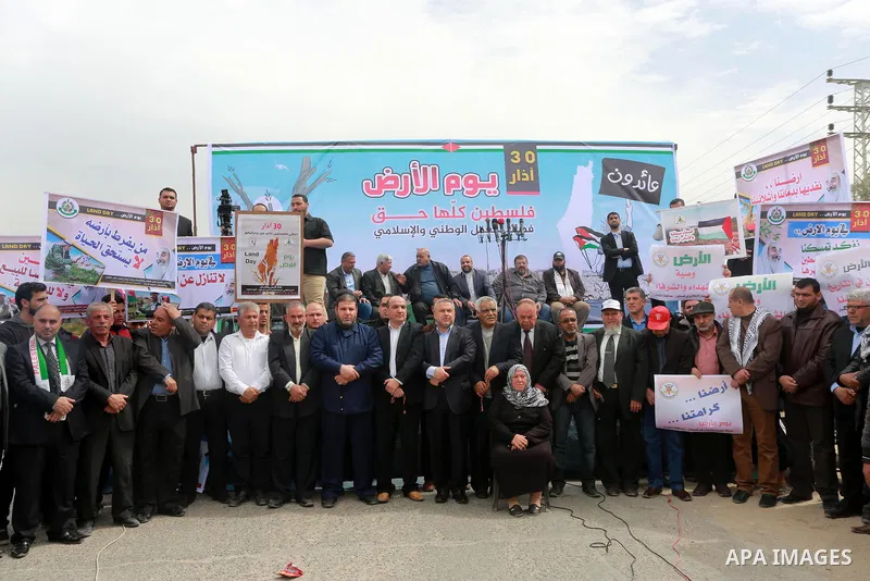 Palestinians hold banners and Palestine flags during a rally marking Land Day, near the Israeli border with northern Gaza Strip March 30, 2017. March 30 marks Land Day, the annual commemorations of the killing by police...