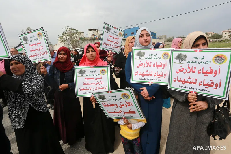 Palestinians hold banners and Palestine flags during a rally marking Land Day, near the Israeli border with northern Gaza Strip March 30, 2017. March 30 marks Land Day, the annual commemorations of the killing by police...