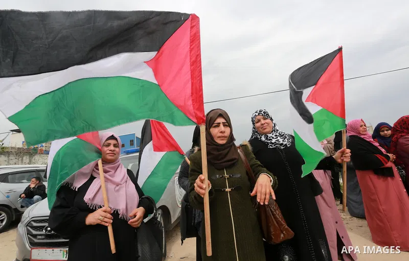 Palestinians hold banners and Palestine flags during a rally marking Land Day, near the Israeli border with northern Gaza Strip March 30, 2017. March 30 marks Land Day, the annual commemorations of the killing by police...