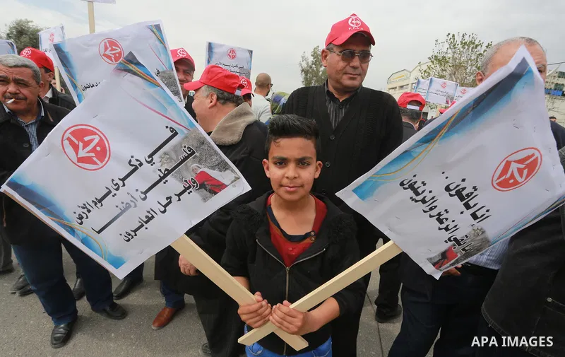 Palestinians hold banners and Palestine flags during a rally marking Land Day, near the Israeli border with northern Gaza Strip March 30, 2017. March 30 marks Land Day, the annual commemorations of the killing by police...