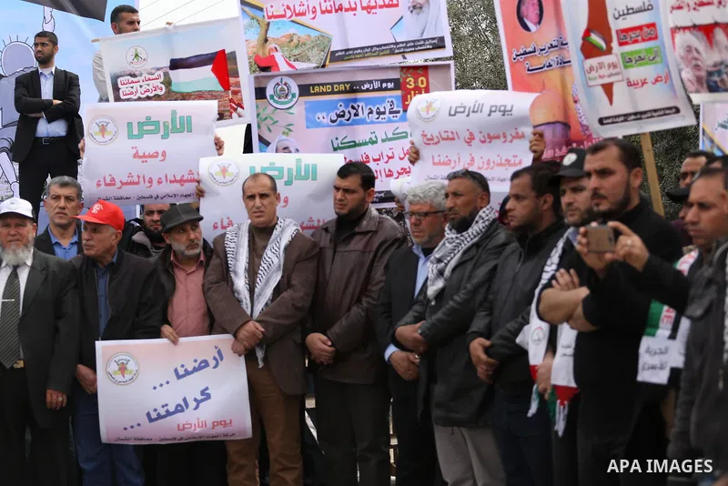 Palestinians hold banners and Palestine flags during a rally marking Land Day, near the Israeli border with northern Gaza Strip March 30, 2017. March 30 marks Land Day, the annual commemorations of the killing by police...