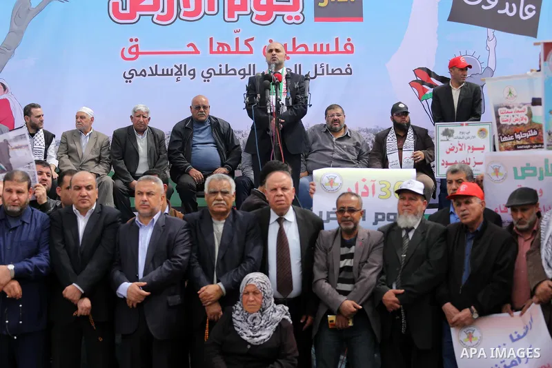 Palestinians hold banners and Palestine flags during a rally marking Land Day, near the Israeli border with northern Gaza Strip March 30, 2017. March 30 marks Land Day, the annual commemorations of the killing by police...
