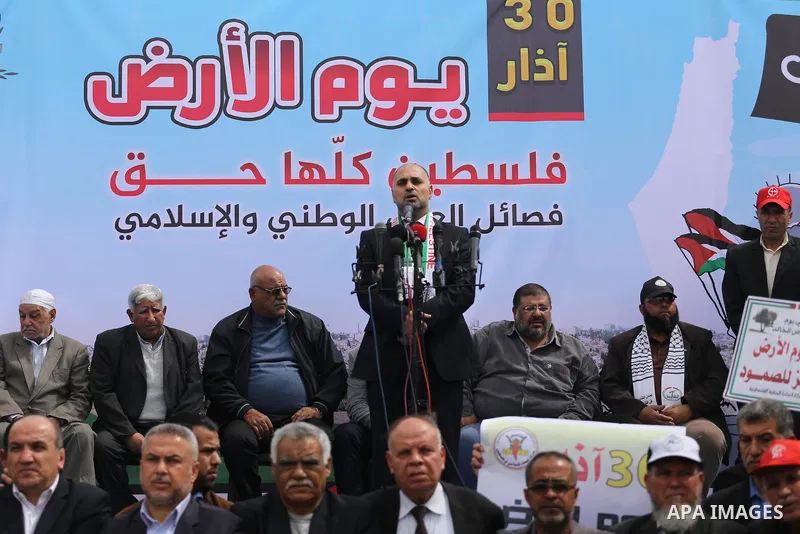 Palestinians hold banners and Palestine flags during a rally marking Land Day, near the Israeli border with northern Gaza Strip March 30, 2017. March 30 marks Land Day, the annual commemorations of the killing by police...