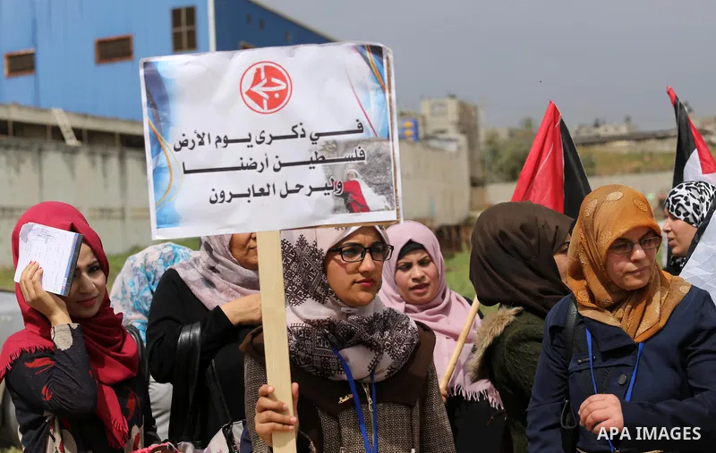 Palestinians hold banners and Palestine flags during a rally marking Land Day, near the Israeli border with northern Gaza Strip March 30, 2017. March 30 marks Land Day, the annual commemorations of the killing by police...