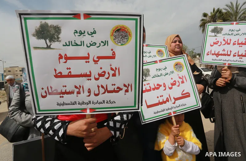 Palestinians hold banners and Palestine flags during a rally marking Land Day, near the Israeli border with northern Gaza Strip March 30, 2017. March 30 marks Land Day, the annual commemorations of the killing by police...