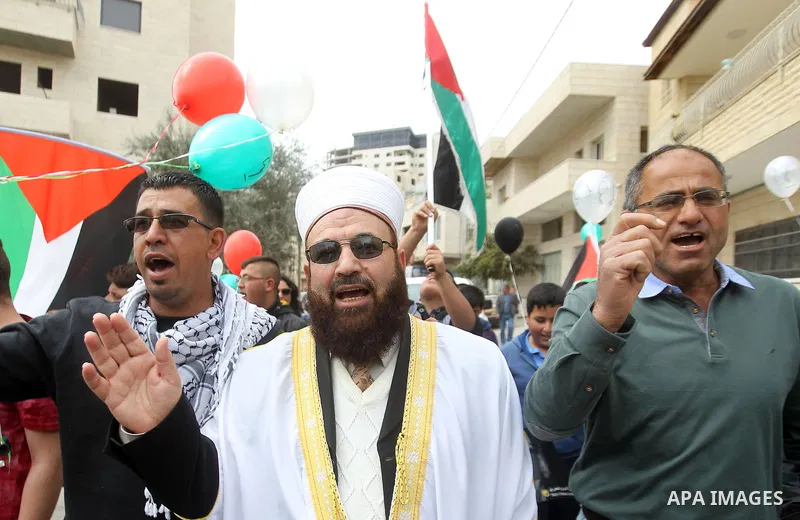 Palestinians hold Palestine flags during a demonstration marking Land Day, in the West Bank city of Beit Jala March 30, 2017. March 30 marks Land Day, the annual commemorations of the killing by police of six Arab citize...