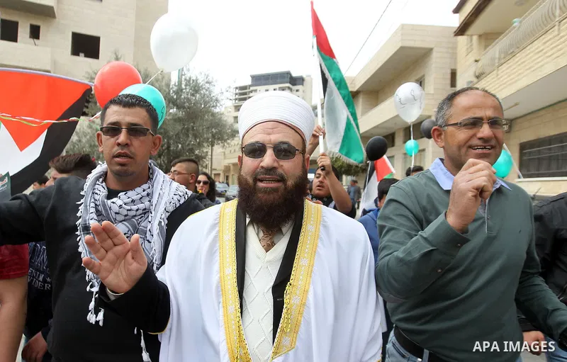 Palestinians hold Palestine flags during a demonstration marking Land Day, in the West Bank city of Beit Jala March 30, 2017. March 30 marks Land Day, the annual commemorations of the killing by police of six Arab citize...