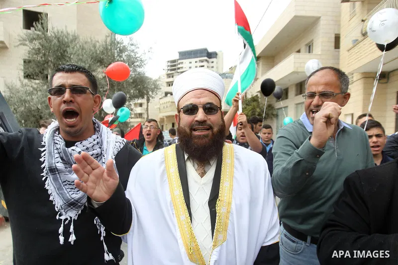 Palestinians hold Palestine flags during a demonstration marking Land Day, in the West Bank city of Beit Jala March 30, 2017. March 30 marks Land Day, the annual commemorations of the killing by police of six Arab citize...