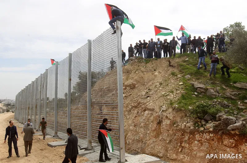 Palestinians hold Palestine flags during a demonstration marking Land Day, in the West Bank city of Beit Jala March 30, 2017. March 30 marks Land Day, the annual commemorations of the killing by police of six Arab citize...