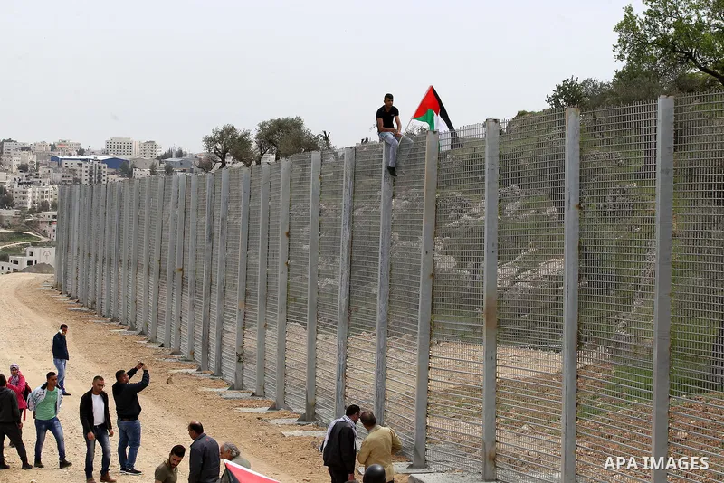 Palestinians hold Palestine flags during a demonstration marking Land Day, in the West Bank city of Beit Jala March 30, 2017. March 30 marks Land Day, the annual commemorations of the killing by police of six Arab citize...