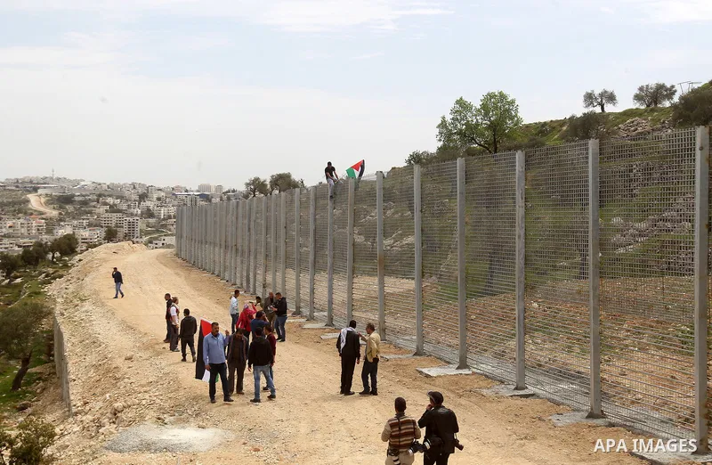 Palestinians hold Palestine flags during a demonstration marking Land Day, in the West Bank city of Beit Jala March 30, 2017. March 30 marks Land Day, the annual commemorations of the killing by police of six Arab citize...