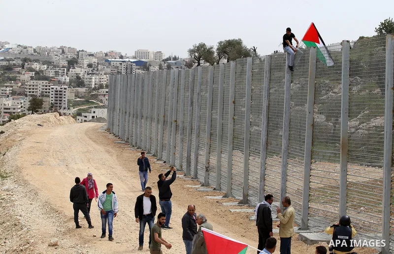 Palestinians hold Palestine flags during a demonstration marking Land Day, in the West Bank city of Beit Jala March 30, 2017. March 30 marks Land Day, the annual commemorations of the killing by police of six Arab citize...
