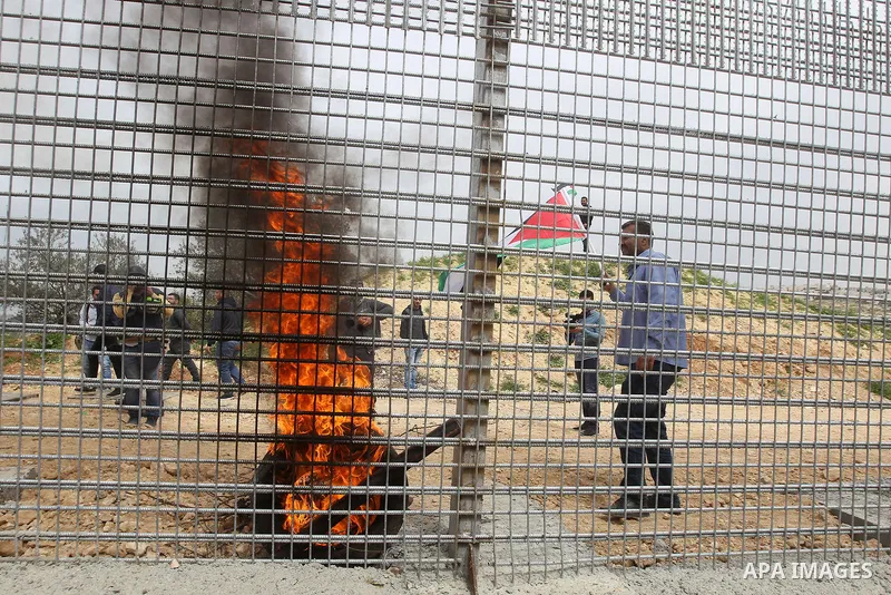 Palestinian demonstrators try to remove a section of the Israeli barrier fence during a protest marking Land Day, in the West Bank city of Beit Jala March 30, 2017. March 30 marks Land Day, the annual commemorations of t...