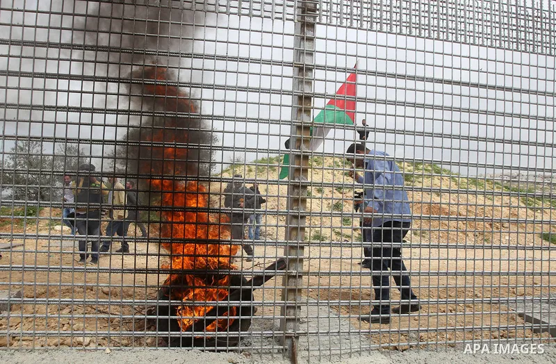 Palestinian demonstrators try to remove a section of the Israeli barrier fence during a protest marking Land Day, in the West Bank city of Beit Jala March 30, 2017. March 30 marks Land Day, the annual commemorations of t...