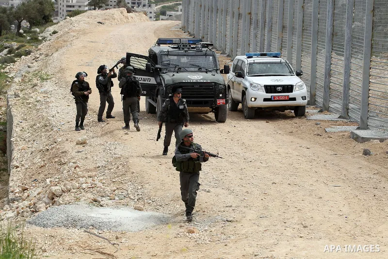 Israeli border policemen fire a tear gas canister towards Palestinian demonstrators during clashes at a protest marking Land Day, in the West Bank city of Beit Jala March 30, 2017. March 30 marks Land Day, the annual com...