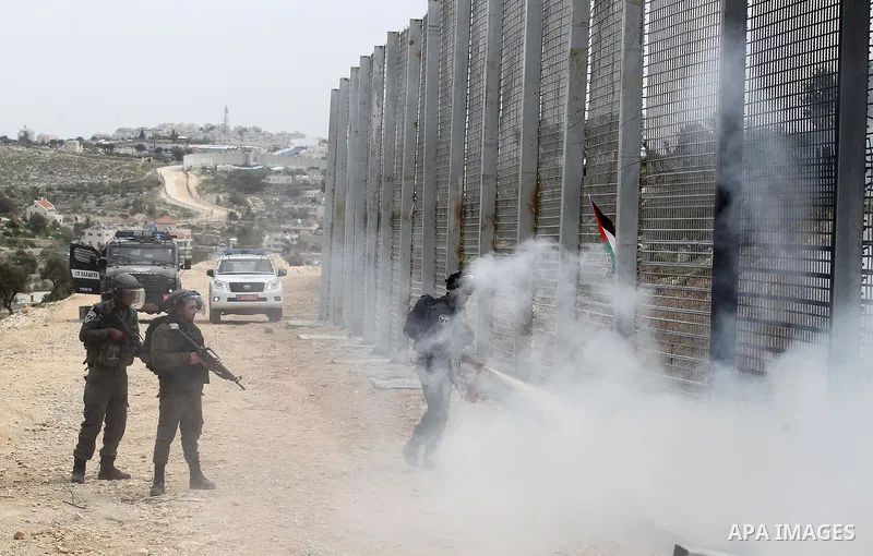 Israeli border policemen fire a tear gas canister towards Palestinian demonstrators during clashes at a protest marking Land Day, in the West Bank city of Beit Jala March 30, 2017. March 30 marks Land Day, the annual com...