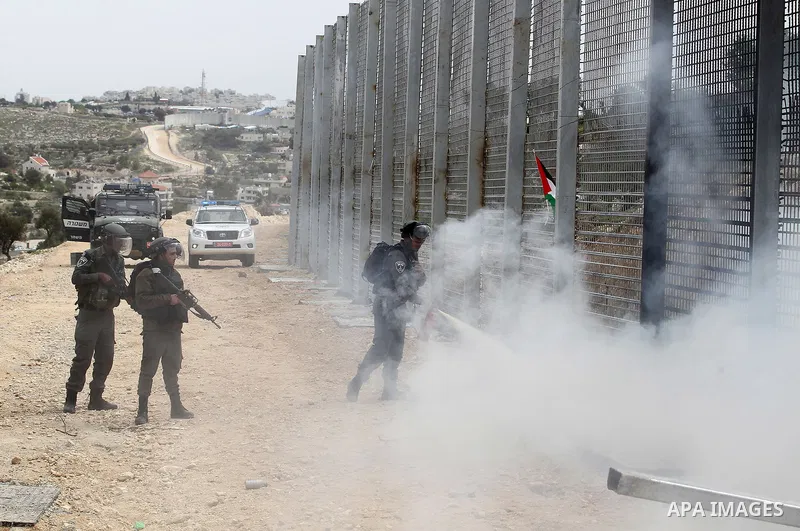 Israeli border policemen fire a tear gas canister towards Palestinian demonstrators during clashes at a protest marking Land Day, in the West Bank city of Beit Jala March 30, 2017. March 30 marks Land Day, the annual com...