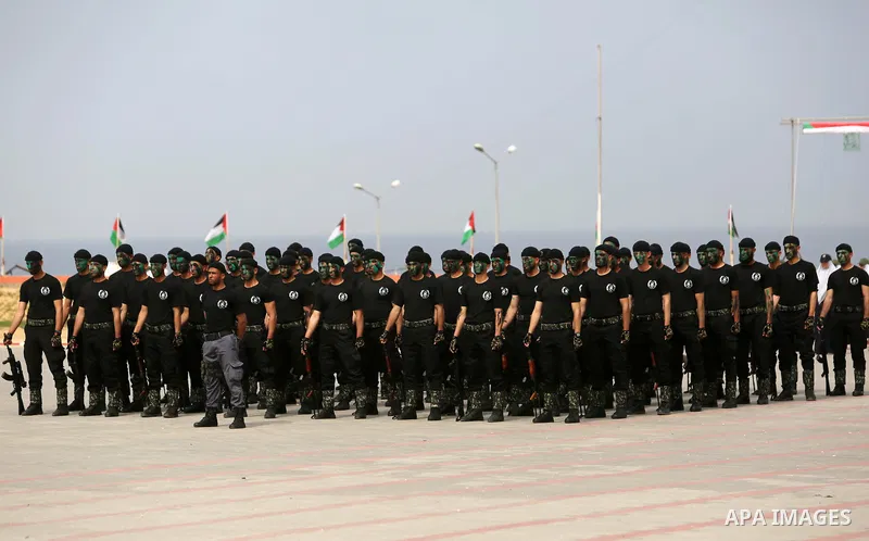 Palestinian police officers loyal to Hamas take part in a graduation ceremony in Gaza City March 30, 2017. Photo by Ashraf Amra