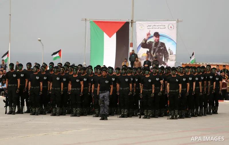 Palestinian police officers loyal to Hamas take part in a graduation ceremony in Gaza City March 30, 2017. Photo by Ashraf Amra