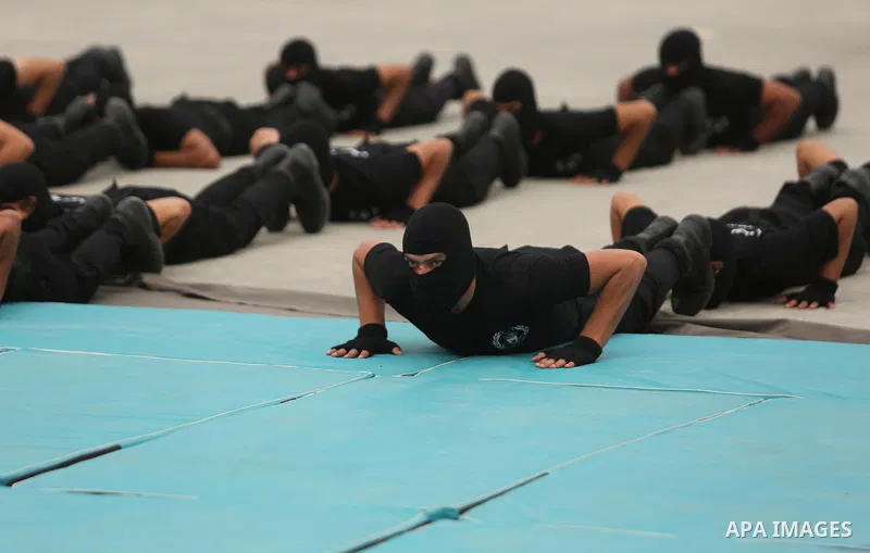 Palestinian police officers loyal to Hamas take part in a graduation ceremony in Gaza City March 30, 2017. Photo by Ashraf Amra