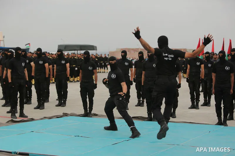 Palestinian police officers loyal to Hamas take part in a graduation ceremony in Gaza City March 30, 2017. Photo by Ashraf Amra
