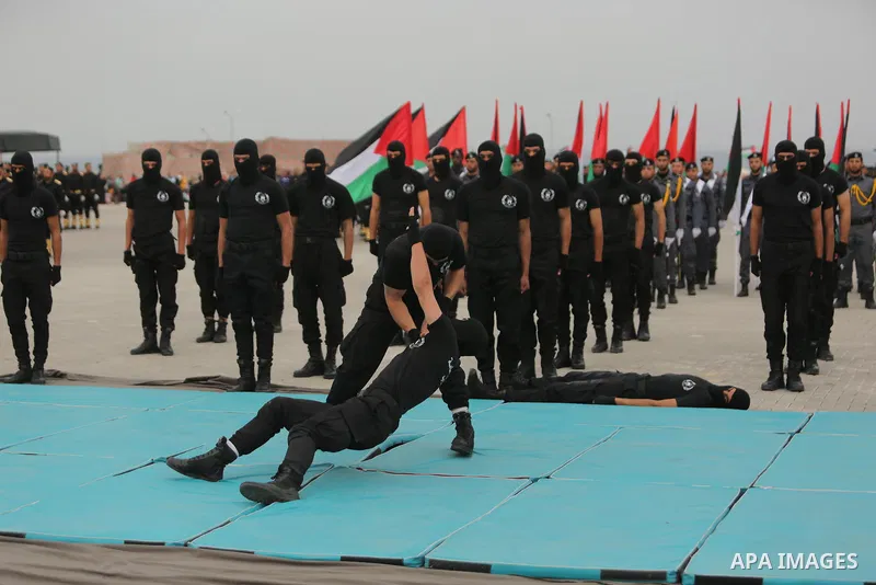 Palestinian police officers loyal to Hamas take part in a graduation ceremony in Gaza City March 30, 2017. Photo by Ashraf Amra