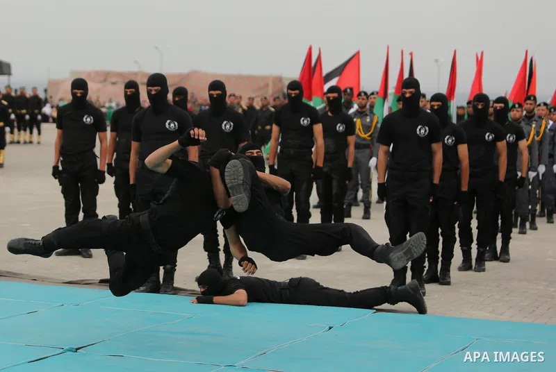 Palestinian police officers loyal to Hamas take part in a graduation ceremony in Gaza City March 30, 2017. Photo by Ashraf Amra